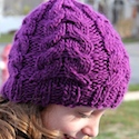 A knit flat cabled hat