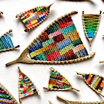 Kaci Smith weaves colorful patterns into miniature looms fashioned from wishbones and branches