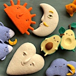 A cast of felted food, animals, and other characters 