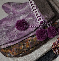 Four pairs of wet-felted mittens
