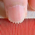 Textile artists file their nails in tiny grooves