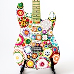 Floral crochet wraps an iconic stratocaster in a psychedelic layer of color