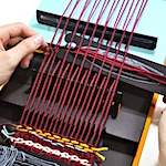 Book on weaving opens to reveal a fully functional loom