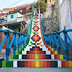 Staircases blanketed with prismatic murals evocative of Andean textiles