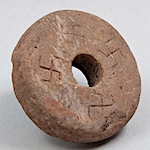 13th century spinning whorl with swastika symbols